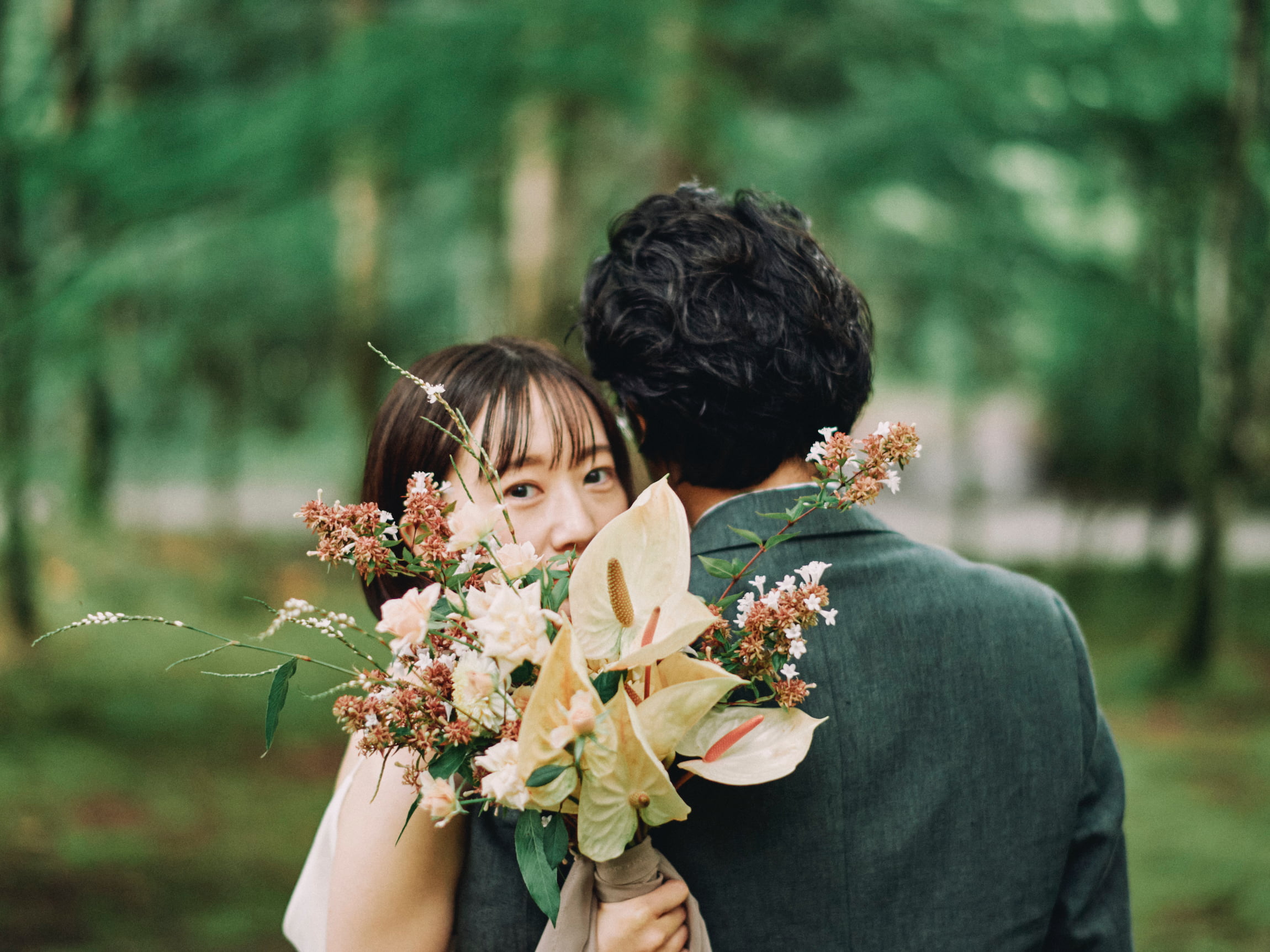 two people looking over a bouquet