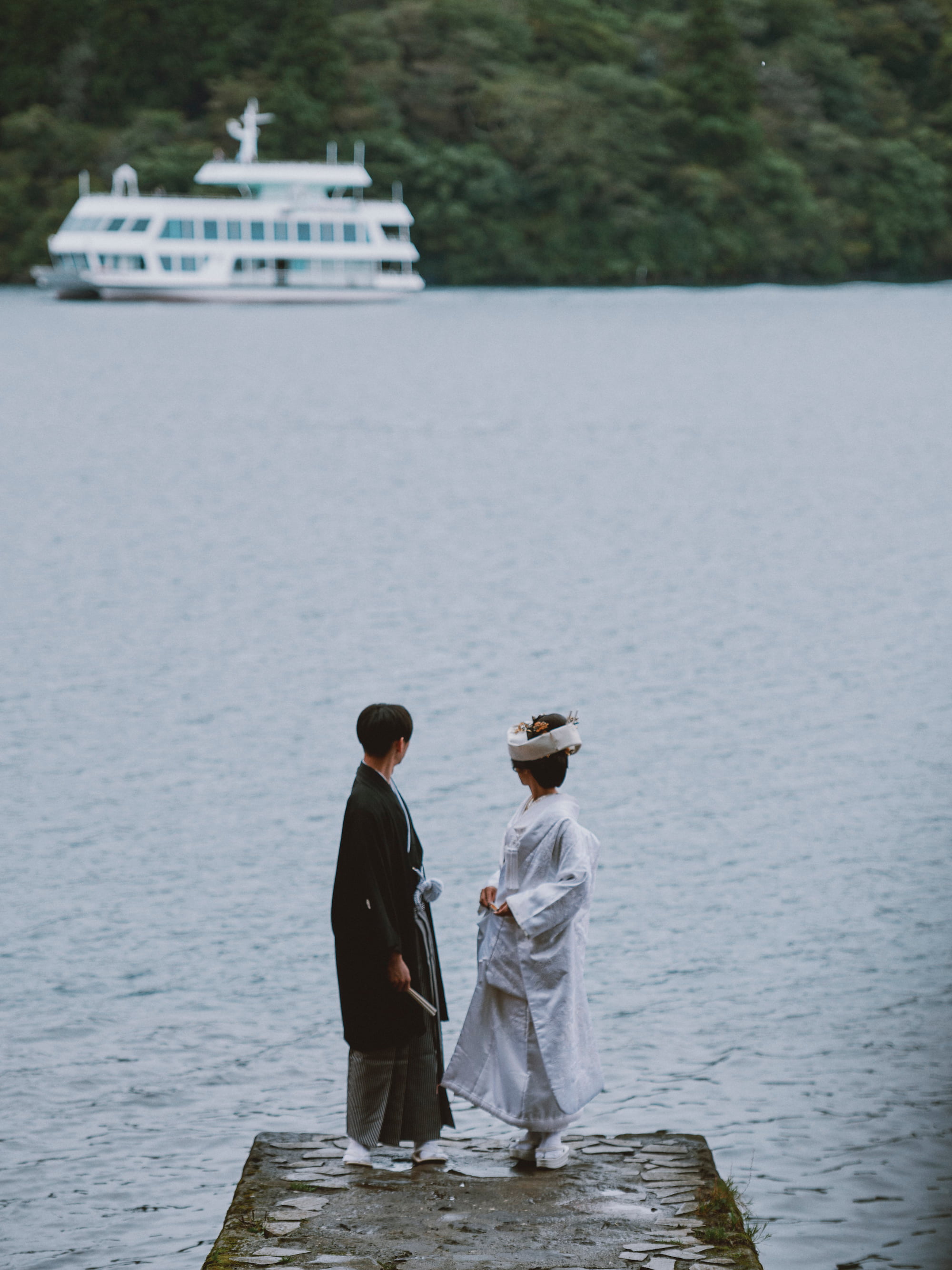 Groom and bride looking back at the ship