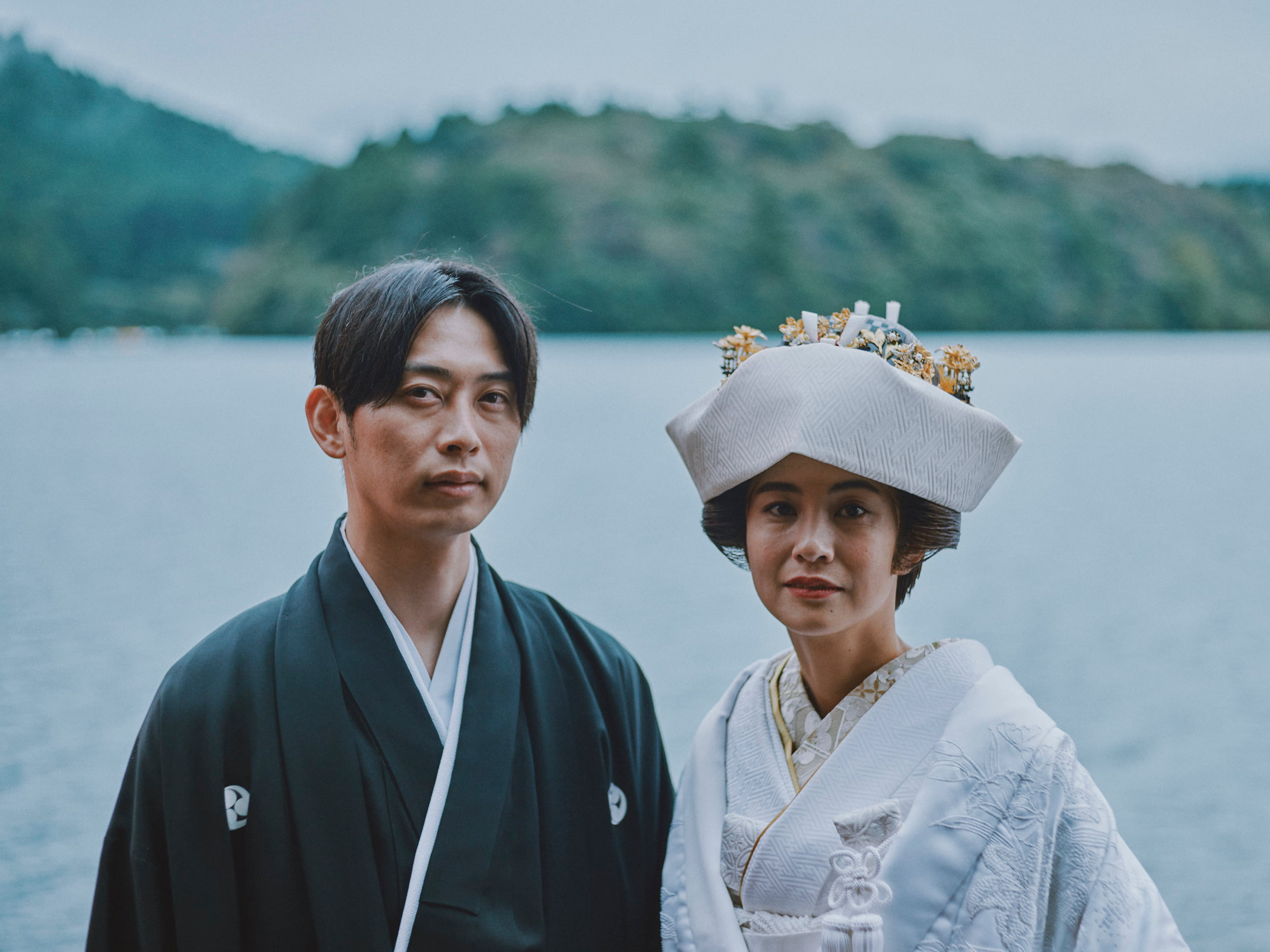 Bride and groom with lake in background