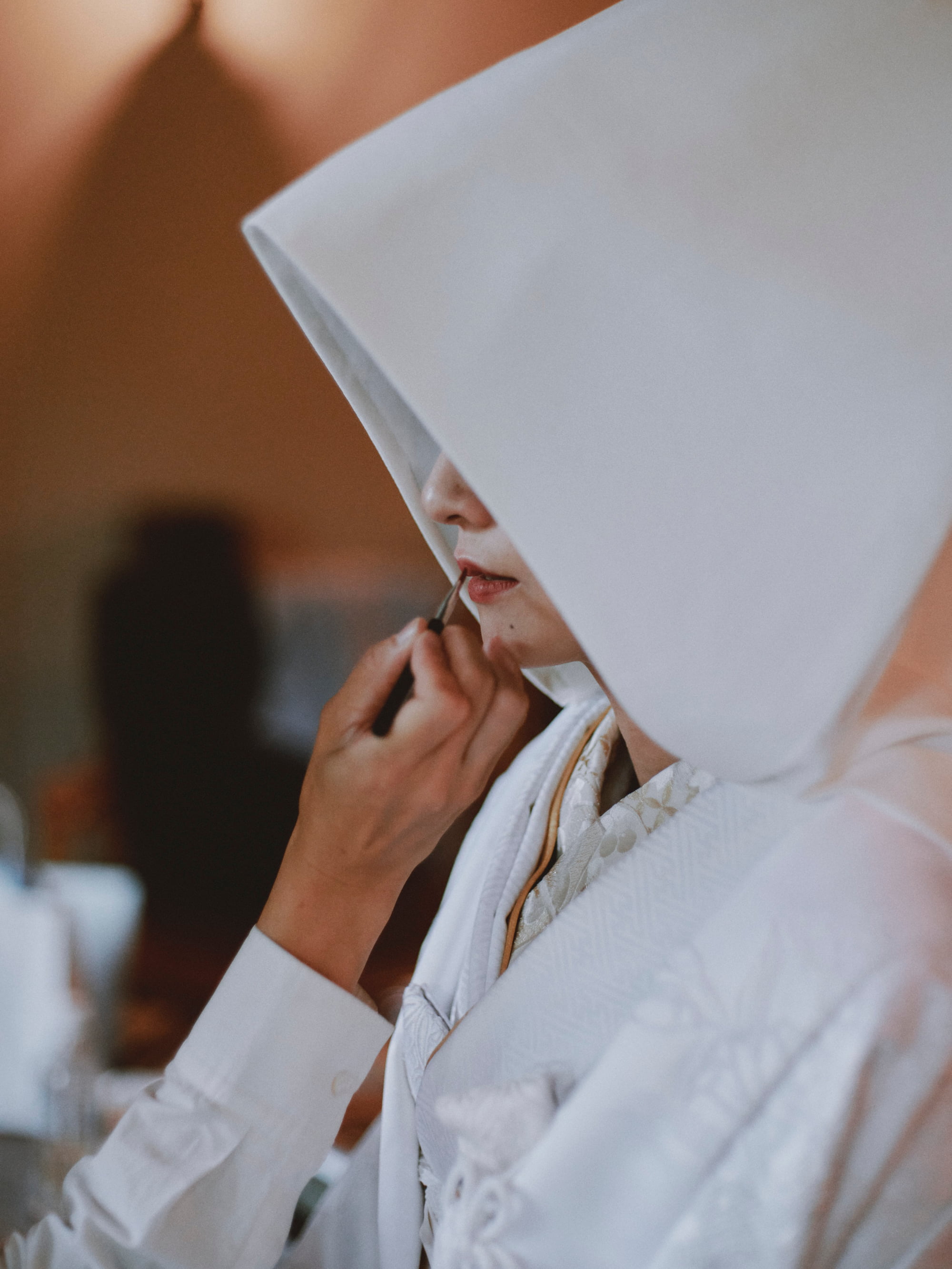 Bride applying lipstick