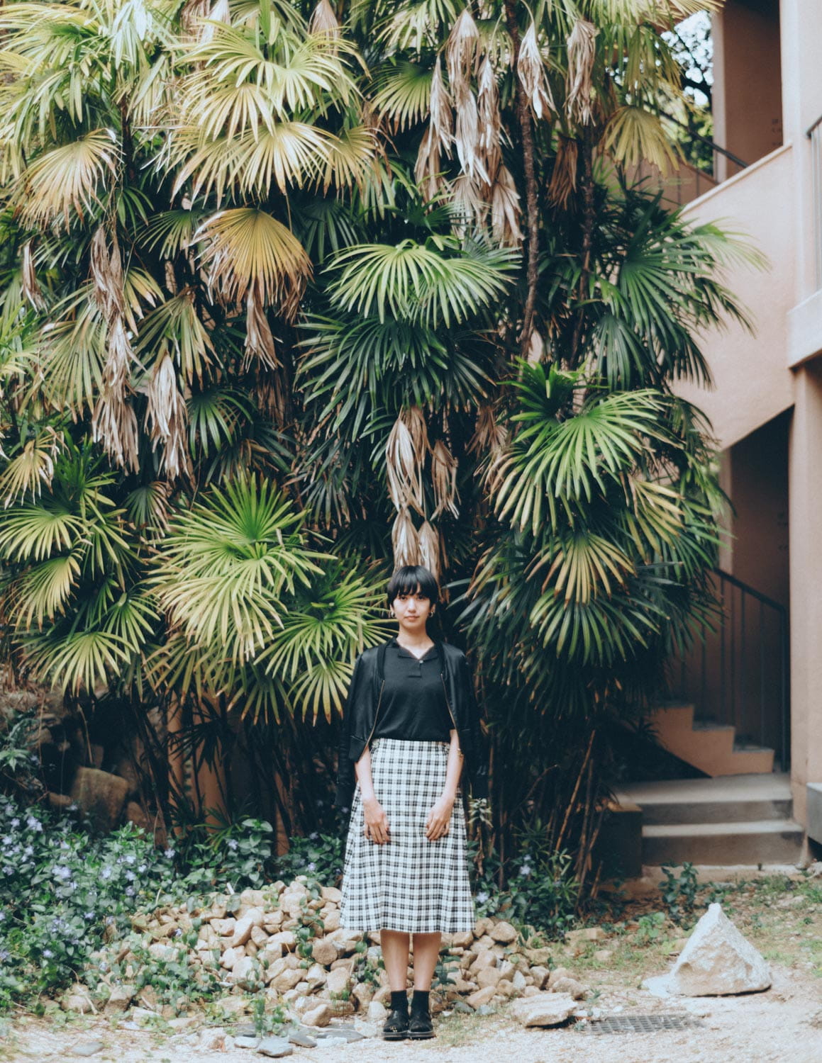 Standing in front of tropical trees